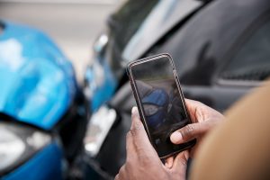 Smartphone taking photos of car accident